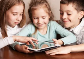 3 kids playing with an ipad